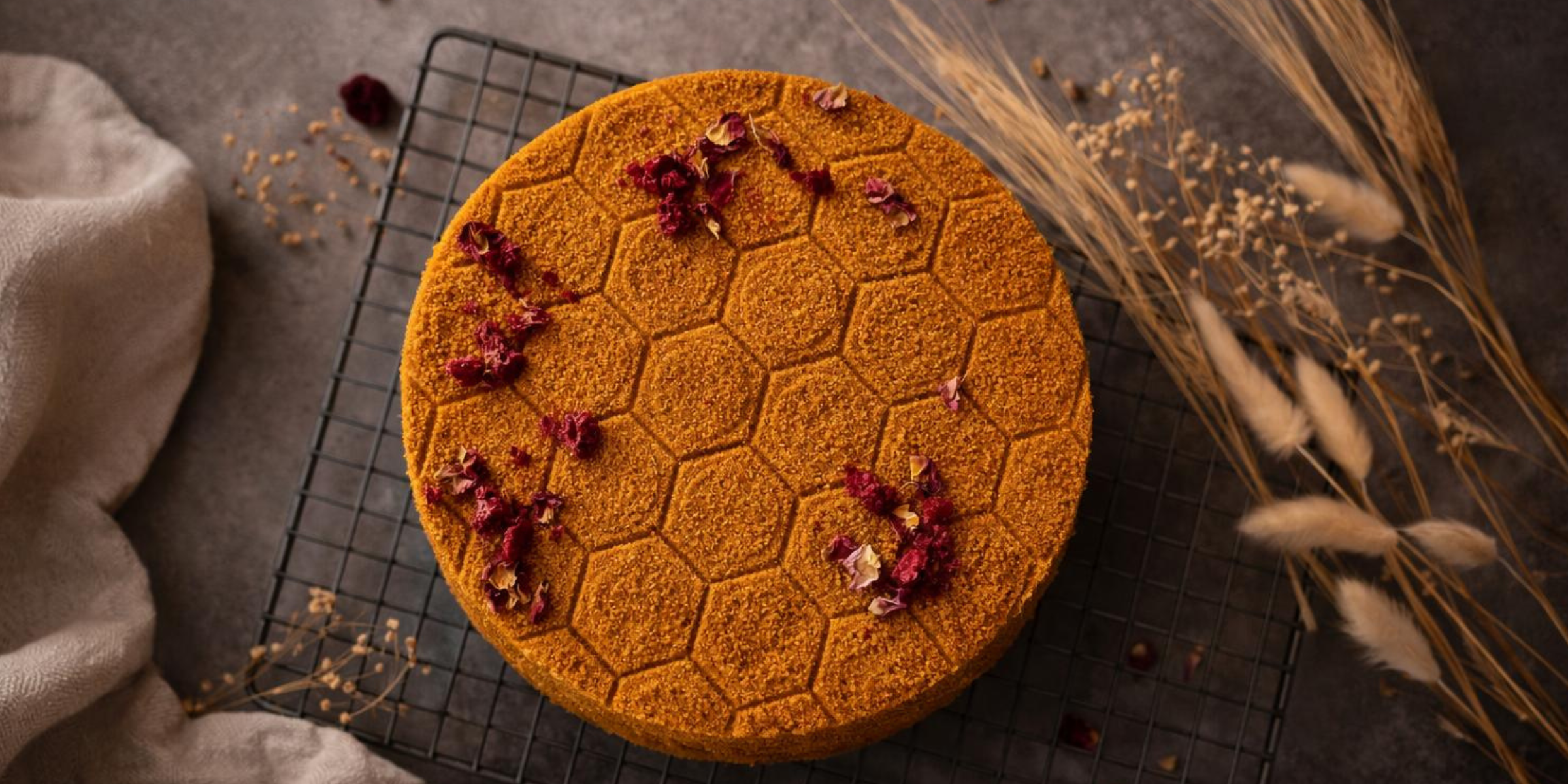 Honey cake with the bunch of dry flowers for decoration